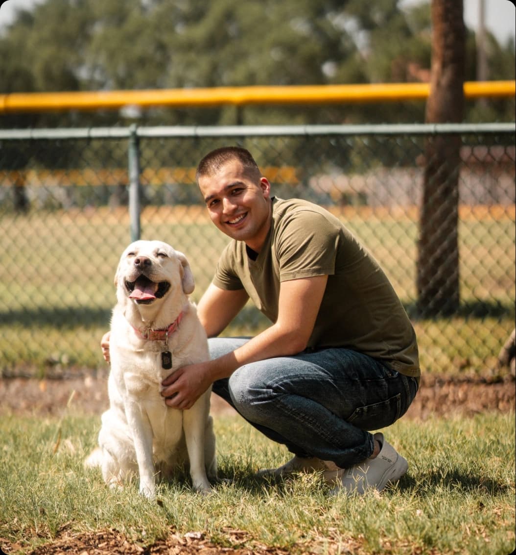 cameron kneeling with dog